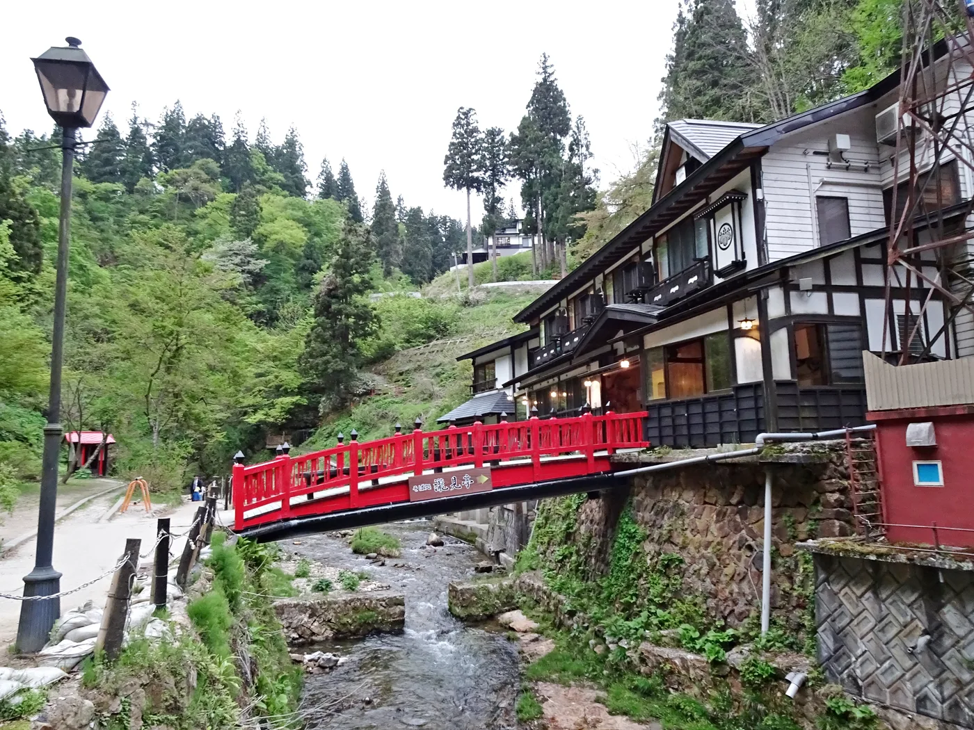 Wooden ryokan and bridge in Ginzan Onsen